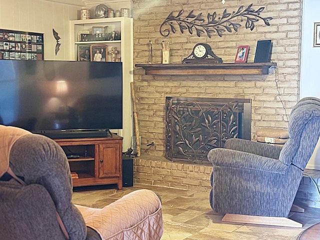 living room featuring a brick fireplace