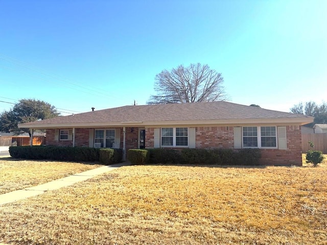 single story home with a front lawn and brick siding