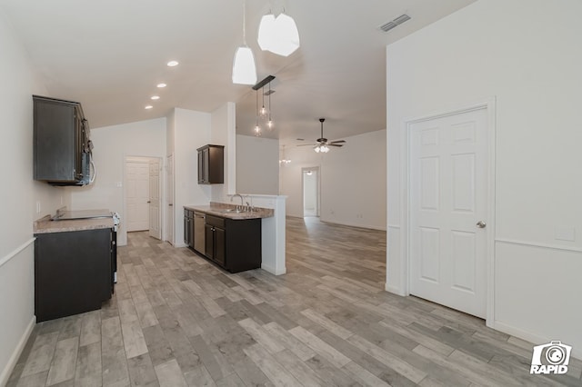 kitchen with light wood-style flooring, visible vents, light countertops, and a ceiling fan