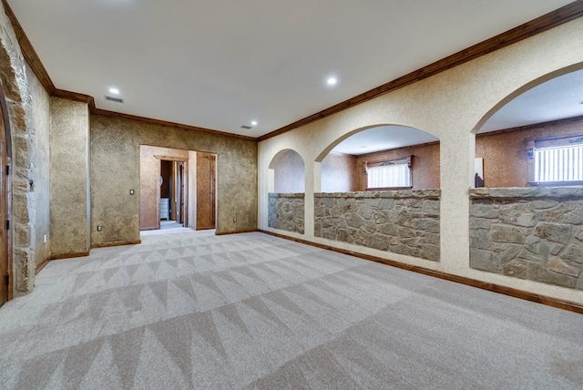 carpeted spare room featuring a healthy amount of sunlight, visible vents, crown molding, and recessed lighting