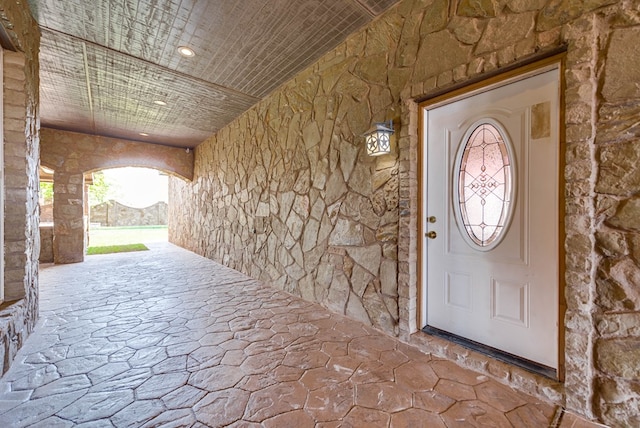 entrance to property featuring stone siding