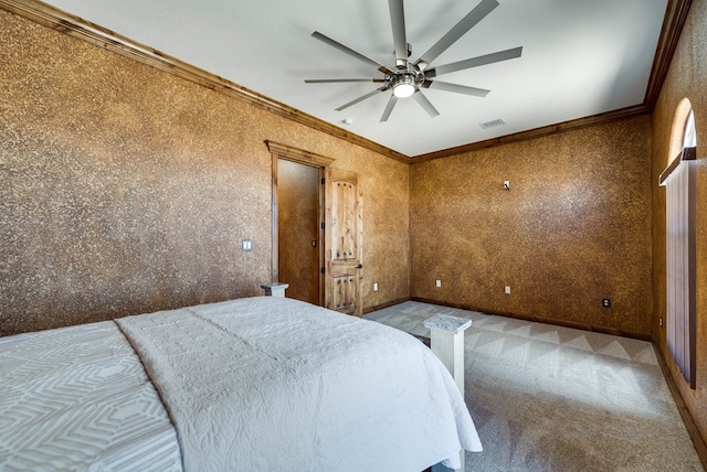 unfurnished bedroom with ceiling fan, carpet floors, visible vents, baseboards, and crown molding