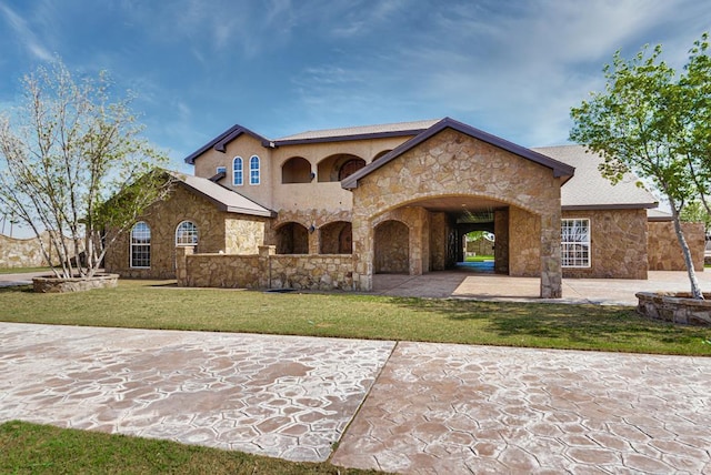 view of front facade with a patio area and a front lawn