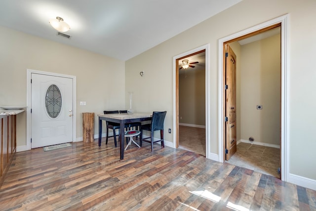 dining area featuring wood finished floors, visible vents, and baseboards