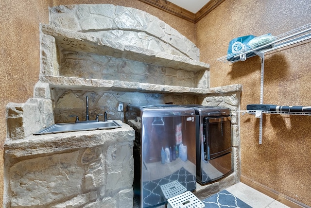 interior details featuring ornamental molding, a sink, and separate washer and dryer