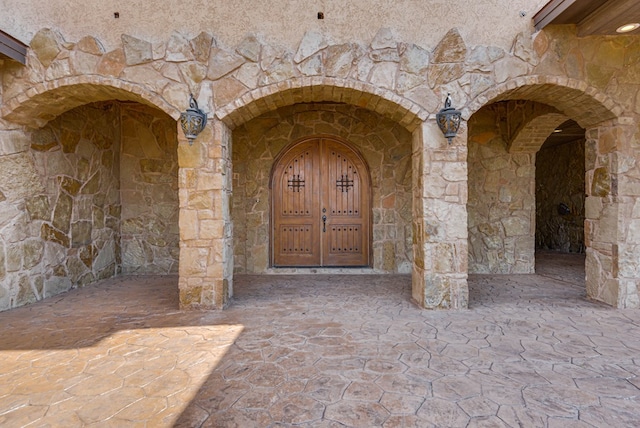 entrance to property with stone siding