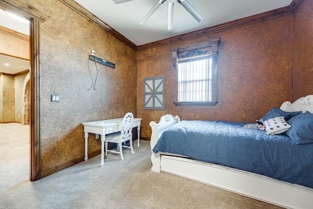 bedroom with carpet floors, ornamental molding, a ceiling fan, and baseboards