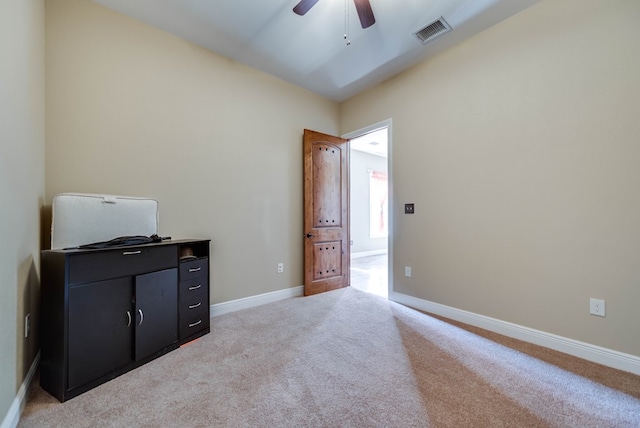 unfurnished bedroom with light carpet, baseboards, visible vents, and a ceiling fan