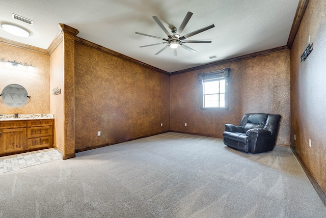 unfurnished room featuring baseboards, visible vents, crown molding, and light colored carpet