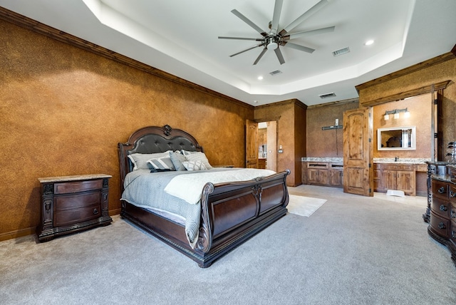 bedroom with a tray ceiling, recessed lighting, visible vents, and light colored carpet