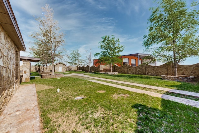 view of yard featuring an outbuilding and fence