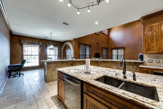 kitchen with stone tile floors, a sink, visible vents, light stone countertops, and dishwasher