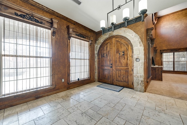 entrance foyer with visible vents and stone tile flooring