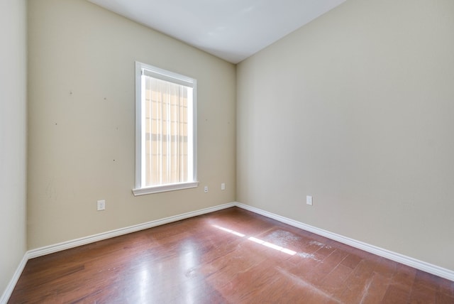 unfurnished room featuring wood finished floors and baseboards