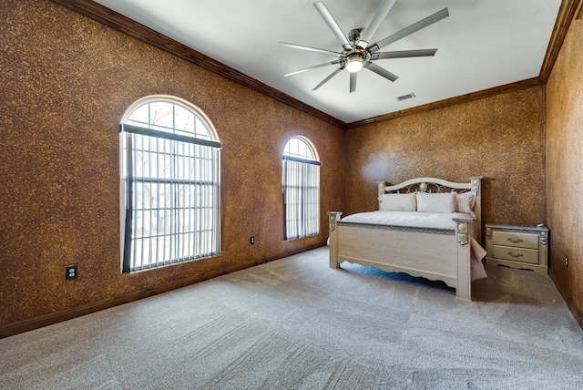 carpeted bedroom featuring ornamental molding, visible vents, baseboards, and a ceiling fan