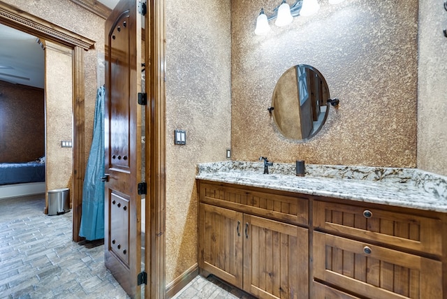 bathroom with vanity and baseboards