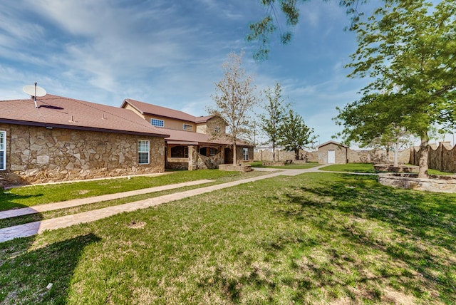 view of yard with an outdoor structure and fence