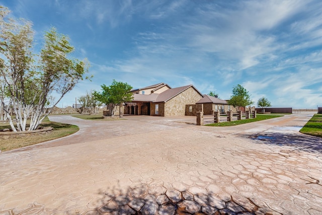 exterior space featuring stone siding and driveway