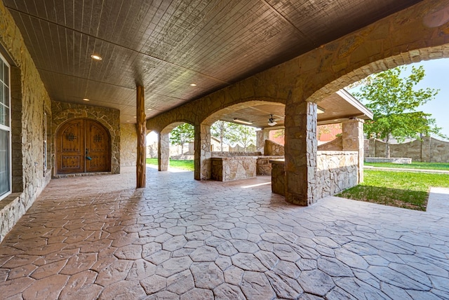 view of patio with exterior kitchen and ceiling fan