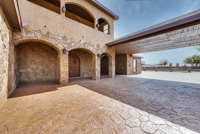 view of patio / terrace with decorative driveway and a balcony