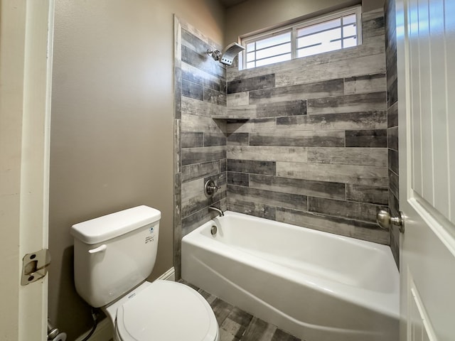 bathroom with toilet, wood-type flooring, and tiled shower / bath