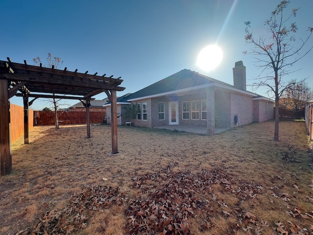 rear view of property featuring a pergola