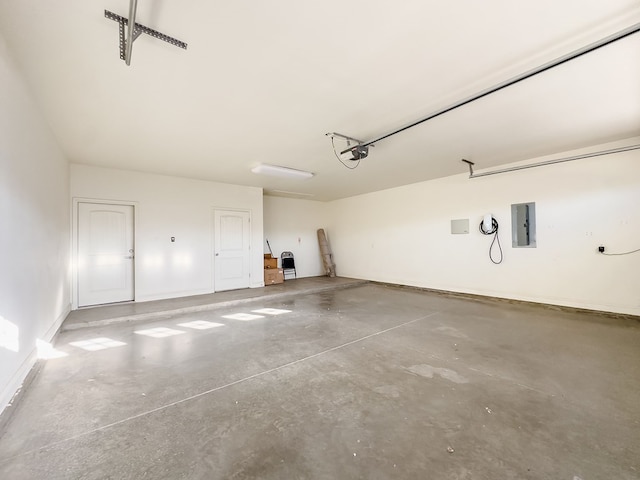 garage with electric panel and a garage door opener