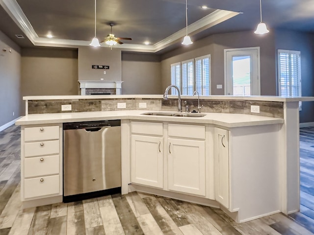 kitchen with white cabinetry, sink, stainless steel dishwasher, and light hardwood / wood-style flooring