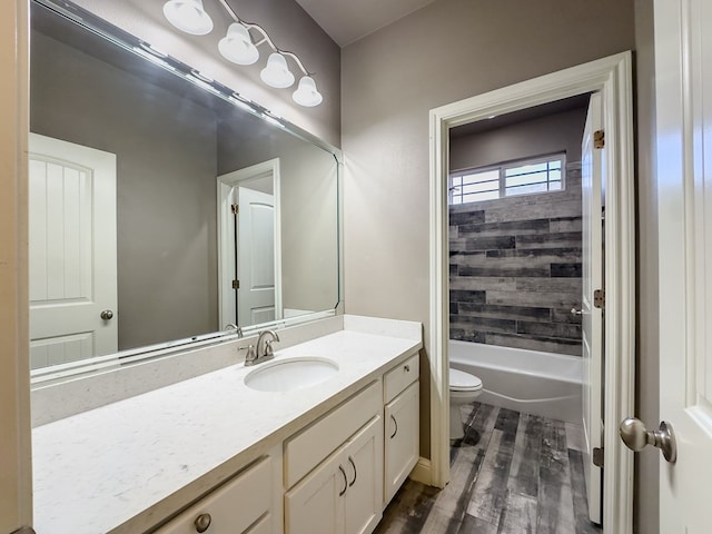 full bathroom with wood-type flooring, vanity, toilet, and tiled shower / bath combo