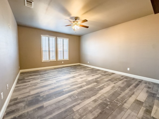 spare room with ceiling fan and wood-type flooring