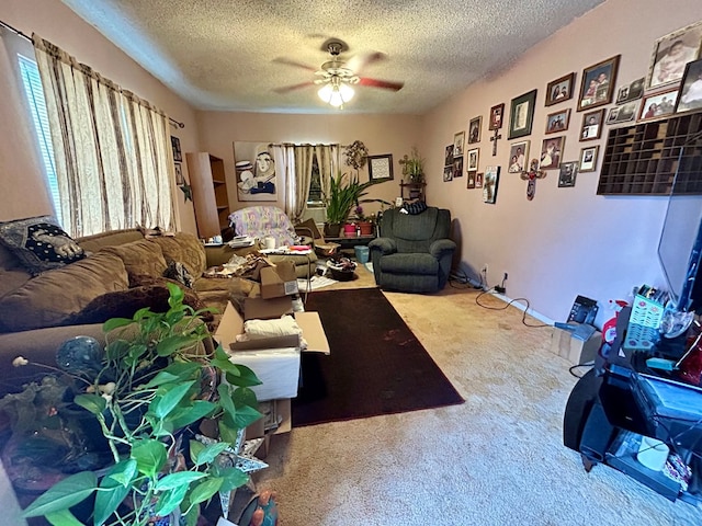 carpeted living room featuring ceiling fan and a textured ceiling