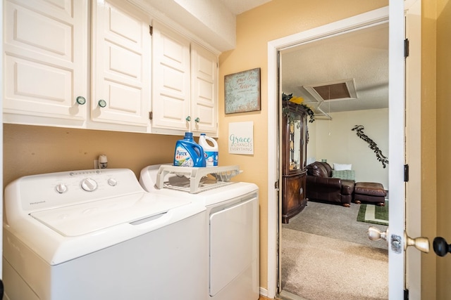 washroom featuring carpet floors, cabinets, a textured ceiling, and independent washer and dryer