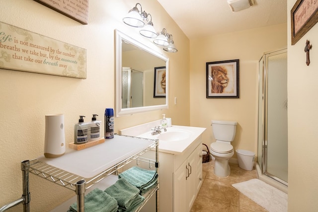 bathroom featuring tile patterned floors, a textured ceiling, vanity, toilet, and a shower with shower door