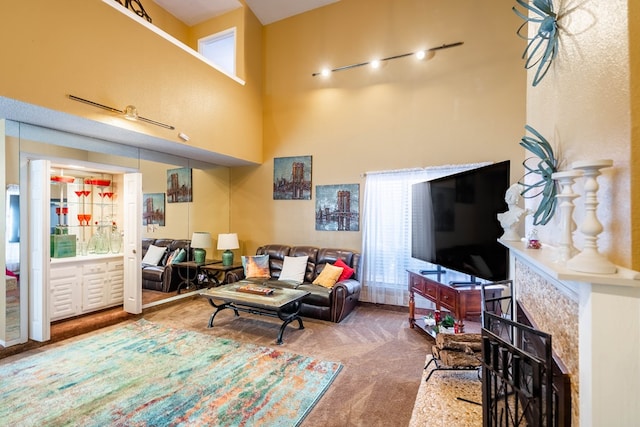 carpeted living room with a towering ceiling