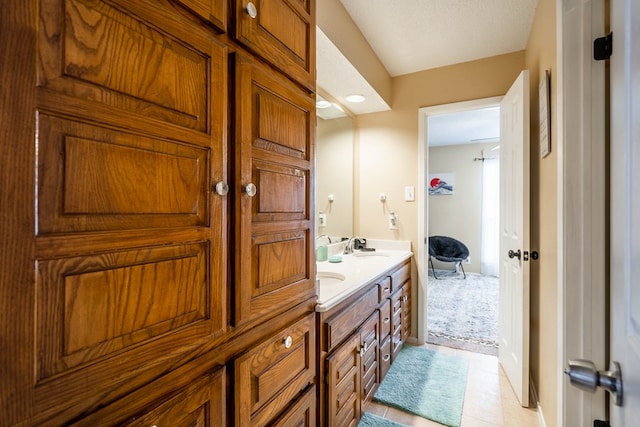 bathroom featuring a textured ceiling, vanity, and tile patterned floors