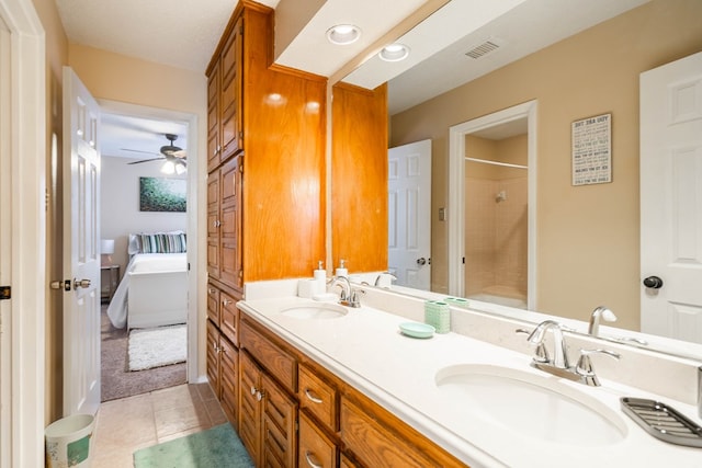 bathroom with tile patterned flooring, ceiling fan, a shower, and vanity