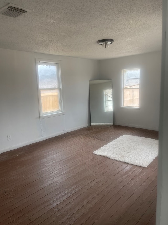 305 S Jackson Ave, Midland, TX 79701 - unfurnished room featuring a textured ceiling and wood-type flooring