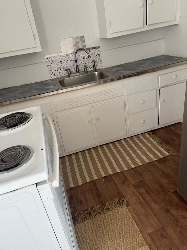 305 S Jackson Ave, Midland, TX 79701 - kitchen with wood finished floors, white cabinets, and tile countertops