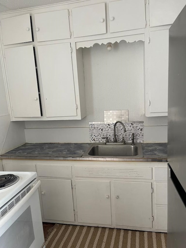 305 S Jackson Ave, Midland, TX 79701 - kitchen with white cabinets and white electric range