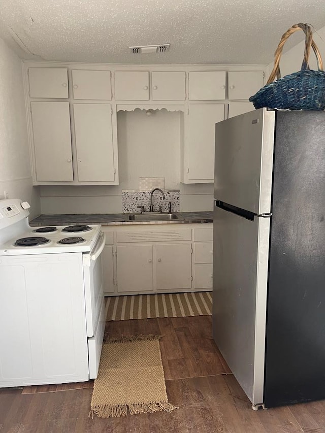 305 S Jackson Ave, Midland, TX 79701 - kitchen featuring freestanding refrigerator, white electric range oven, wood finished floors, and white cabinetry