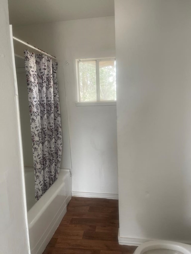 305 S Jackson Ave, Midland, TX 79701 - full bathroom with wood finished floors and shower / bath combo with shower curtain