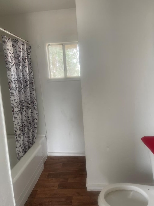305 S Jackson Ave, Midland, TX 79701 - full bath with shower / tub combo with curtain and wood finished floors