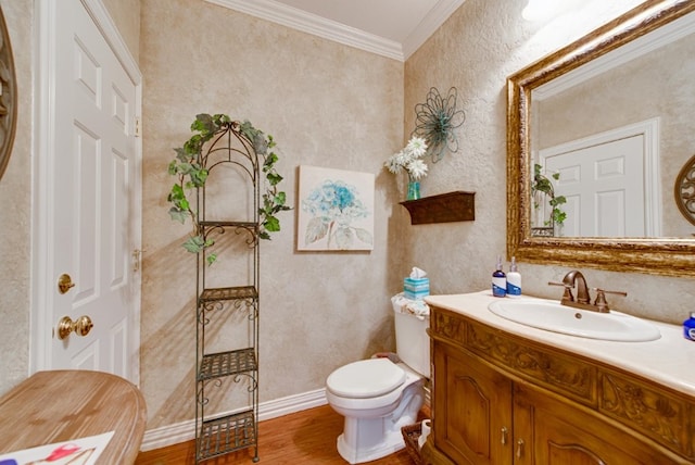 half bath with crown molding, vanity, toilet, and wood finished floors