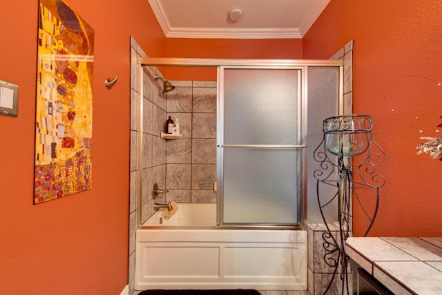 bathroom featuring ornamental molding and bath / shower combo with glass door