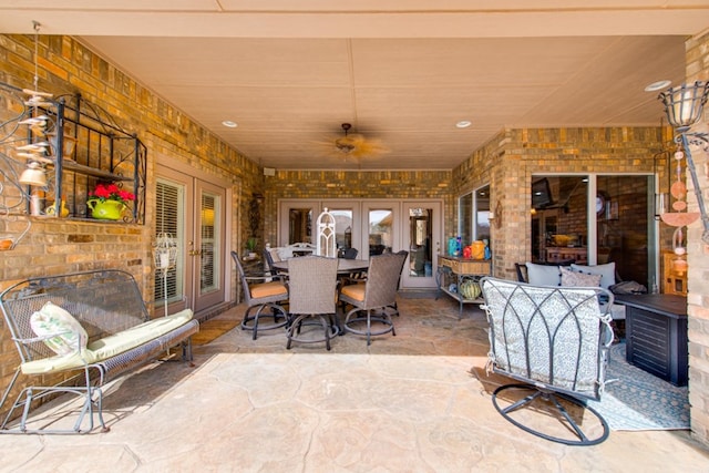 view of patio featuring french doors, outdoor dining space, and a ceiling fan