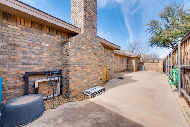 view of patio / terrace featuring fence and central AC