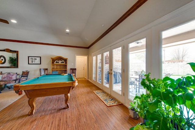 game room with french doors, ornamental molding, vaulted ceiling, wood finished floors, and billiards