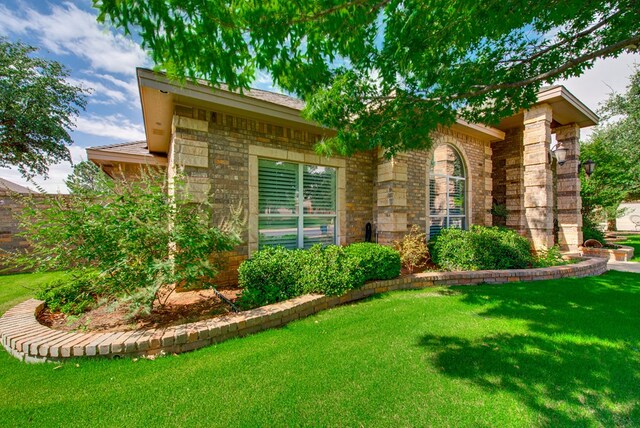 4609 Woodbar Ct, Midland, TX 79707 - view of front of home featuring a front lawn and stone siding
