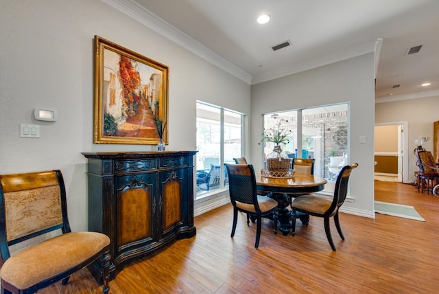 dining room featuring recessed lighting, wood finished floors, visible vents, and crown molding