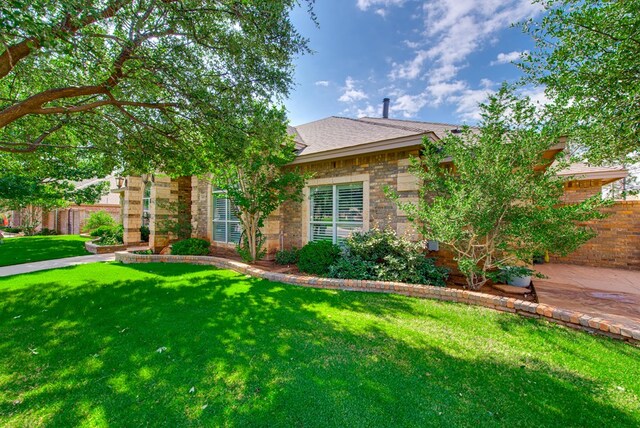4609 Woodbar Ct, Midland, TX 79707 - obstructed view of property with a shingled roof and stone siding